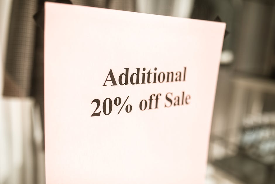 Close-up of a sale sign offering an additional 20% discount in a store window.