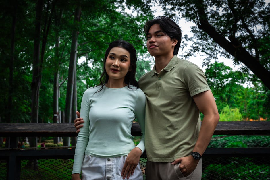 A joyful couple enjoying a moment together in a lush Indonesian park.