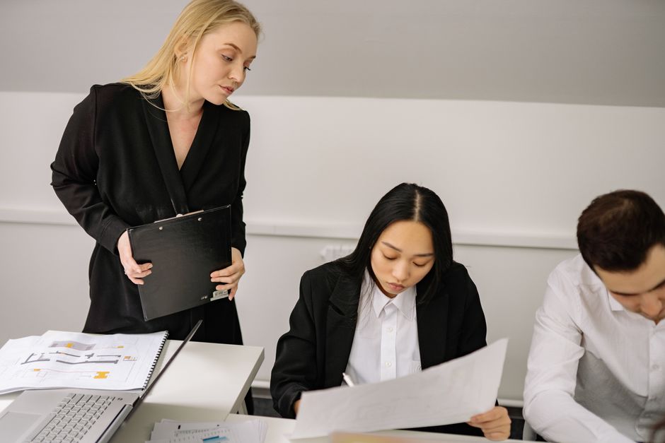 A diverse group of professionals engaged in a discussion during an office meeting.