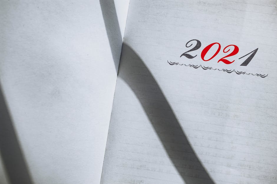Close-up of an open planner showing the year 2021 with minimalist styling and shadows.